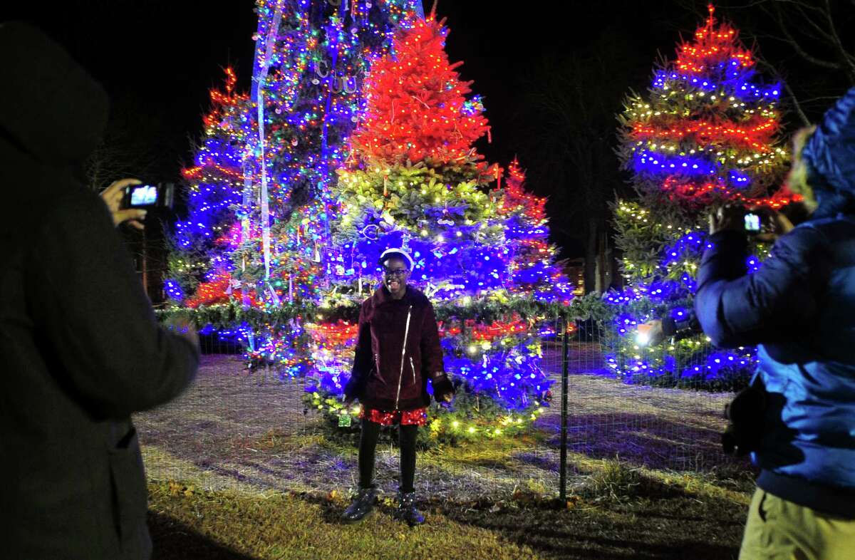 Adia Lars, 12, of New Haven, sings a Christmas carol as family make a video of her in front of the lit Christmas trees during the West Haven Tree Lighting and Holiday Festival on the Green in downtown West Haven, Conn., on Saturday Nov. 30, 2019.