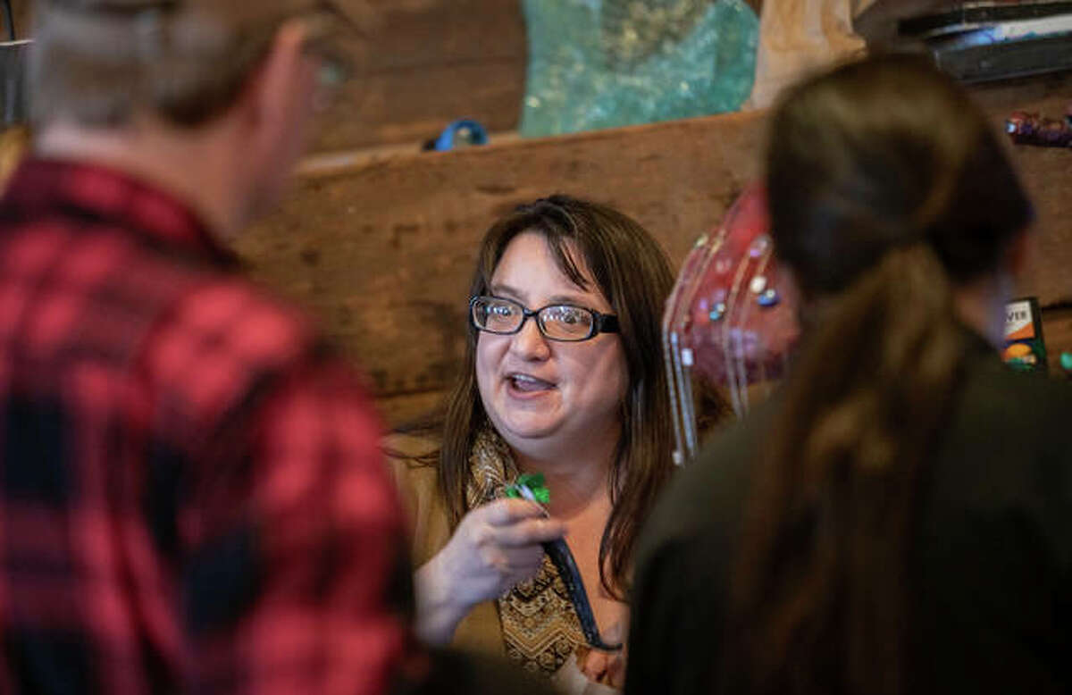 Alton-area artist Adriana Daniel speaks with guests Saturday at the Green Gift Bazaar, held at Post Commons in Alton. The event, co-sponsored by Alton Main Street and the Sierra Club, saw more than 1,000 guests peruse local handmade art and crafts.