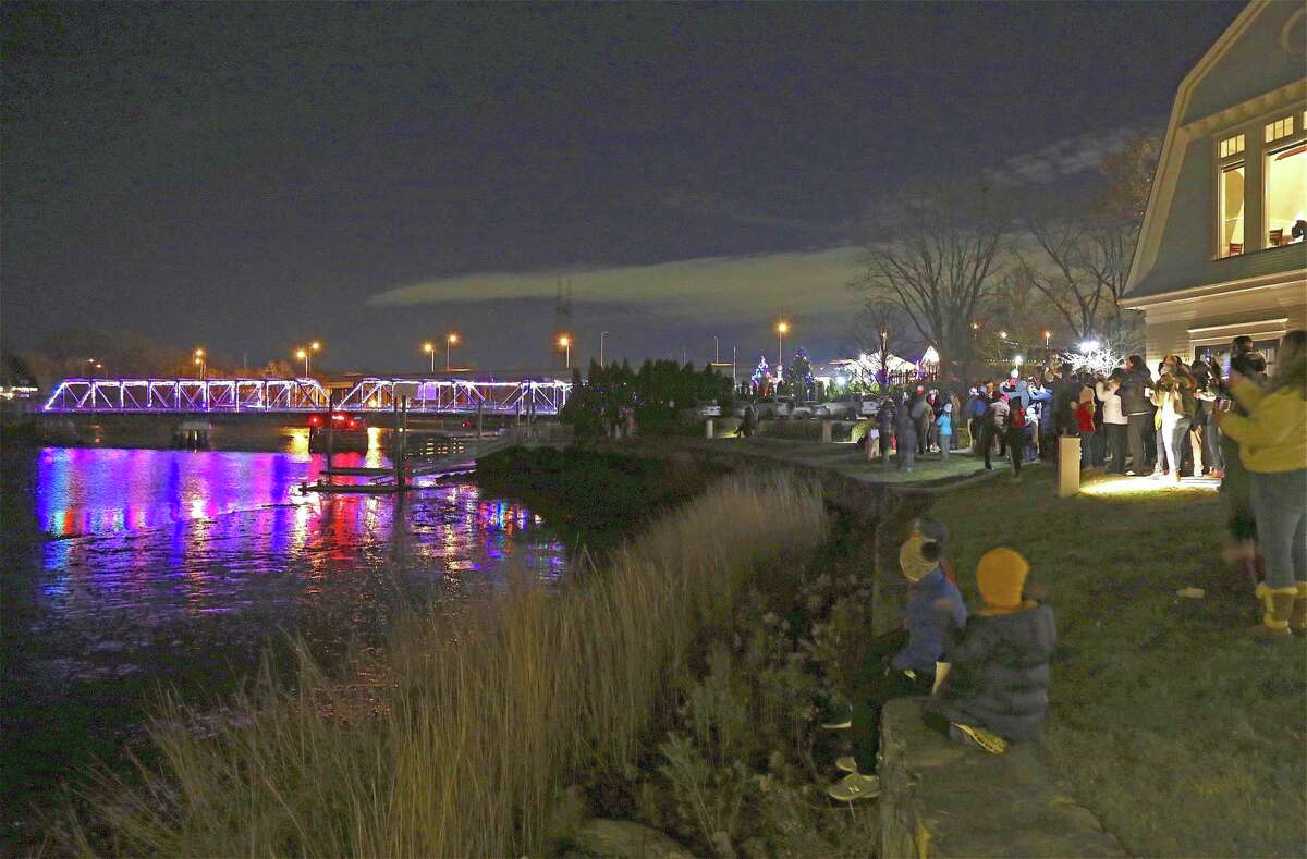 The crowd watches the lights turn on on the historic Cribari Bridge at the Saugatuck Bridge Lighting Holiday Festival at the Saugatuck Rowing Club on Nov. 29, 2019, in Westport.