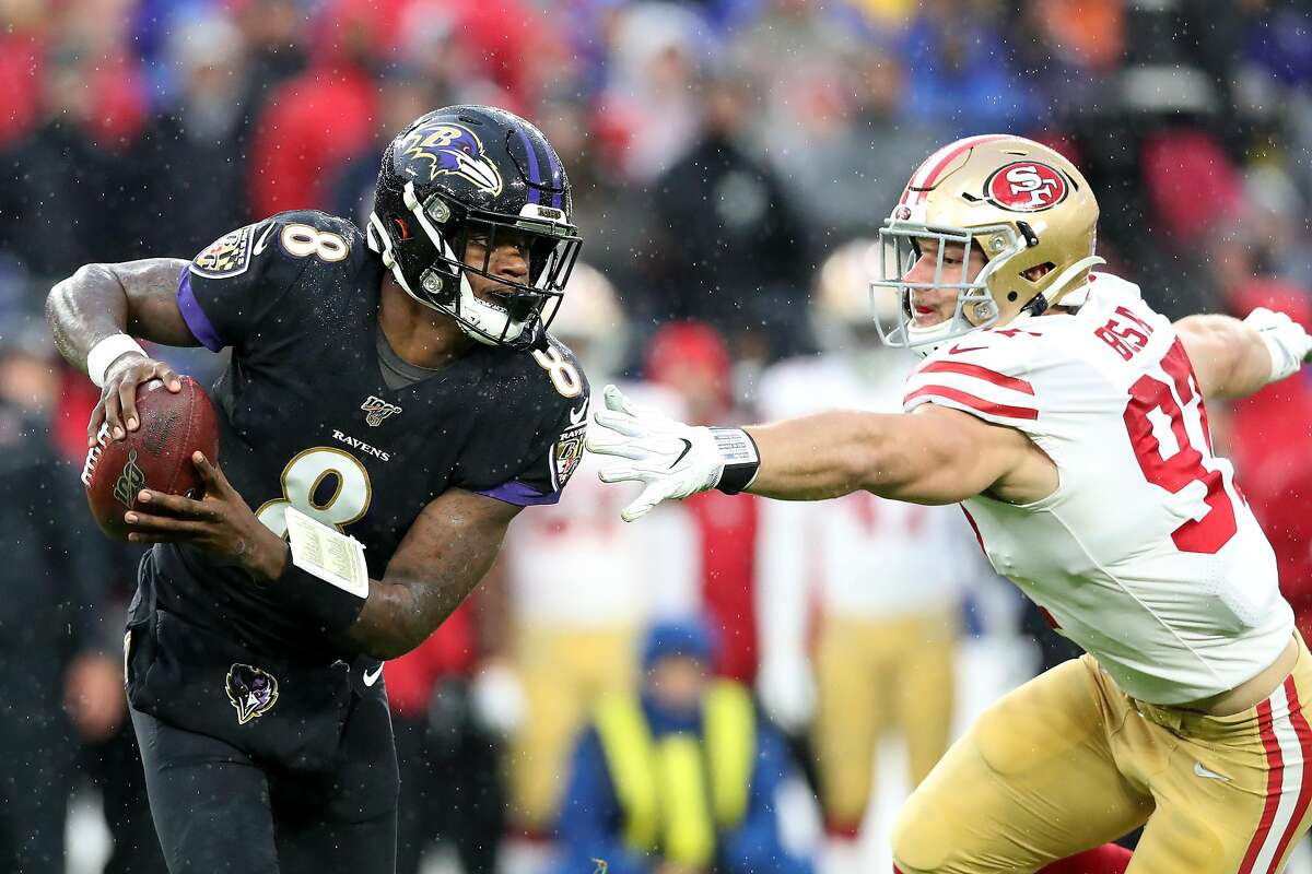 BALTIMORE, MARYLAND - DECEMBER 01: Quarterback Lamar Jackson #8 of the Baltimore Ravens scrambles in front of Nick Bosa #97 of the San Francisco 49ers in the first half at M&T Bank Stadium on December 01, 2019 in Baltimore, Maryland. (Photo by Rob Carr/Getty Images)