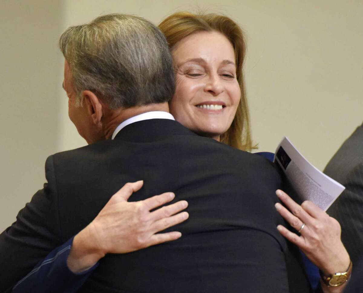 Selectwoman Jill Oberlander gives a hug to First Selectman Fred Camillo after being sworn in at the Board of Selectmen swearing-in ceremony at the Boys & Girls Club of Greenwich in Greenwich, Conn. Sunday, Dec. 1, 2019. Republican Fred Camillo was sworn in as First Selectman, while fellow Republican Lauren Rabin and Democrat Jill Oberlander were sworn in as Selectwomen.