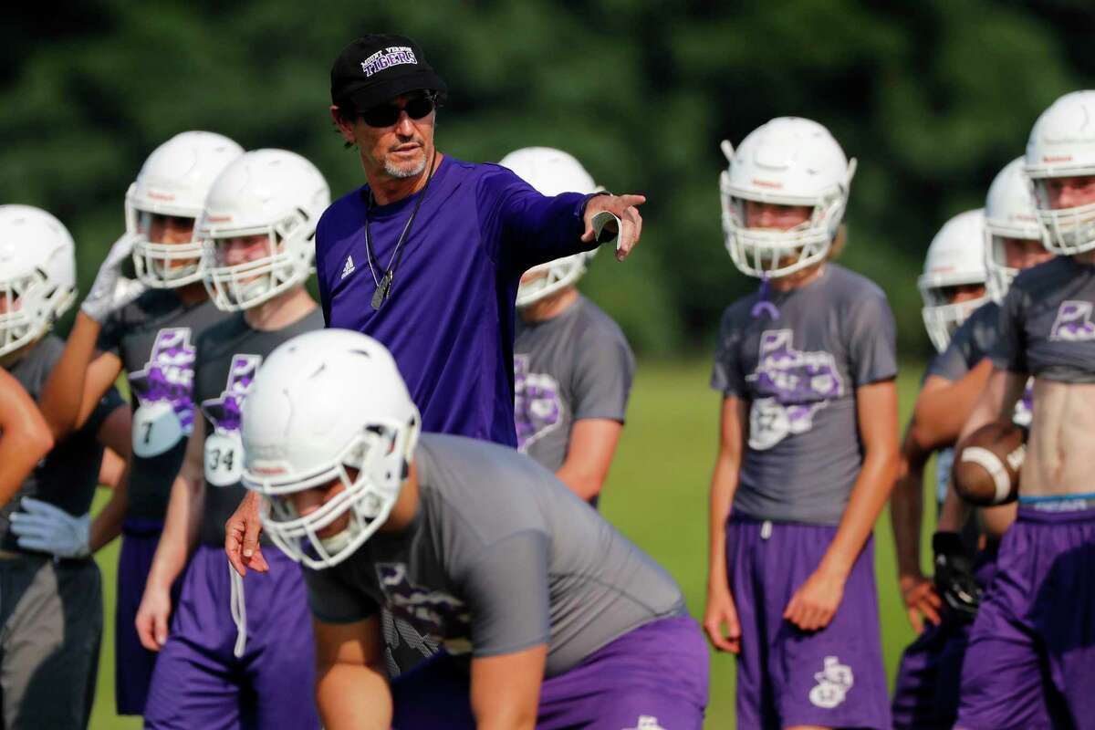 In this Aug. 5, 2019, photo, head coach Art Briles instructs his team during a practice at Mount Vernon High Schoo in Mount Vernon, Texas. Most of the town’s residents knew nothing about the possibility of Briles becoming coach until the school board unanimously approved his hiring in a special meeting on the Friday night going into Memorial Day weekend. (AP Photo/Tony Gutierrez)