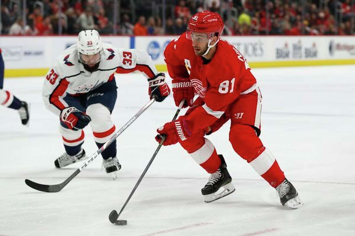 Detroit Red Wings center Frans Nielsen (81) controls the puck next to Washington Capitals defenseman Radko Gudas (33) during the second period of an NHL hockey game Saturday, Nov. 30, 2019, in Detroit. (AP Photo/Carlos Osorio)