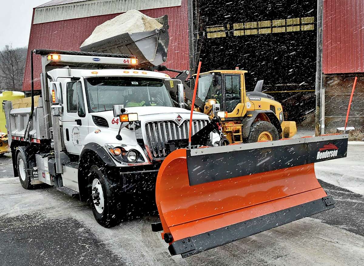 New Haven, Connecticut - Sunday, December, 1, 2019: A New Haven Department of Public Works pay loader dumps salt into its snowplow trucks Sunday afternoon as the City of New Haven prepares to attack the snowstorm with its snow removal teams.