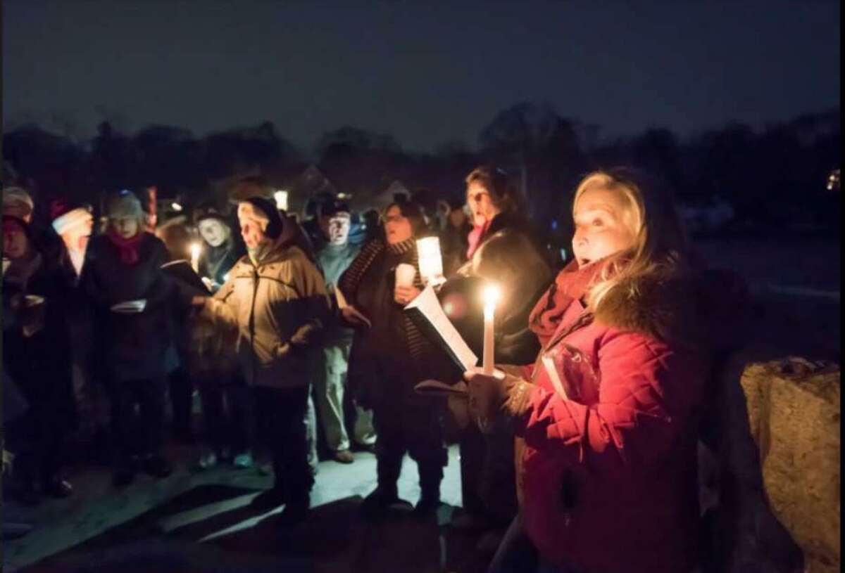 A scene from the first Friends of Gorham's Pond caroling at Rings End Bridge in Darien in 2017. It will return to the Pond this year after moving to Pear Tree Point Beach in 2018.