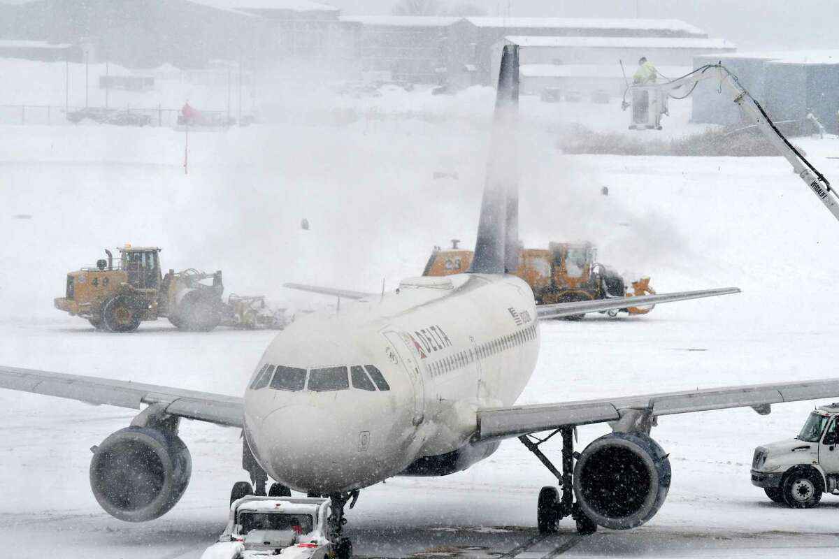 Aircraft are deiced at Albany International Airport as a slow-moving snowstorm sweeps through the Capital Region on Monday, Dec. 2, 2019, in Colonie, N.Y. (Will Waldron/Times Union)