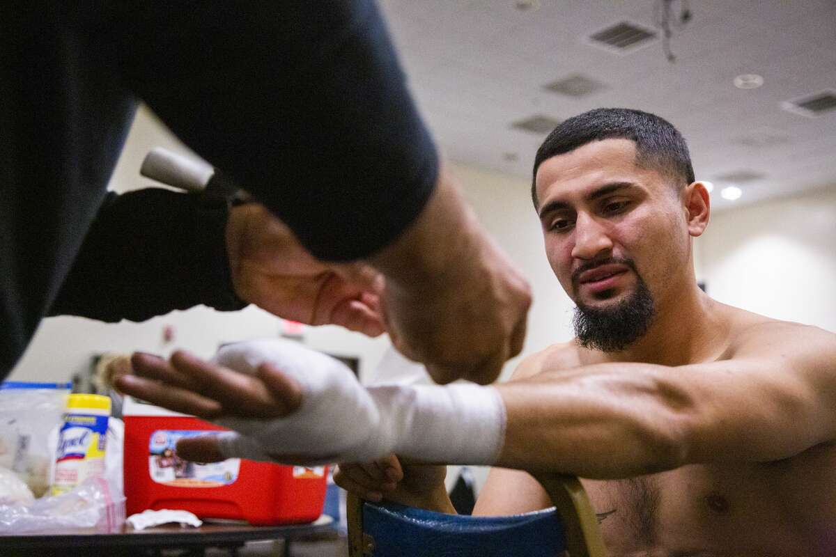 Joseph Rivera, 22, gets his wrists wrapped before a boxing match against Ariel Vasquez on Saturday, Nov. 23, 2019, in Houston.
