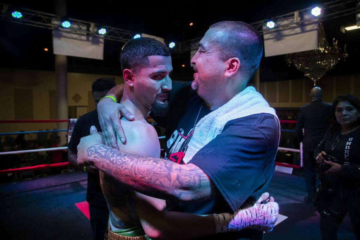 Joseph Rivera, 43, embraces his son Joseph Rivera, 22, after the fighter's boxing match against Ariel Vasquez at Houston's Arabia Shrine Center on Nov. 23, 2019,. It was a big moment for the Riveras' 713 Boxing Gym and came after a devastating month in which the club was broken into and valuable equipment and trophies stolen.