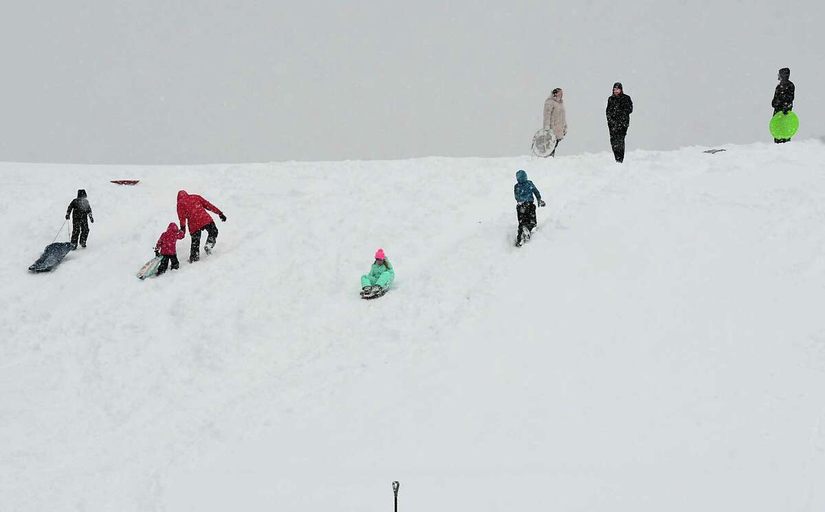 Families are seen sledding on a hill in Frear Park during a major snow storm on Monday, Nov. 2, 2019 in Troy, N.Y. The local schools had a snow day because of the snow.(Lori Van Buren/Times Union)