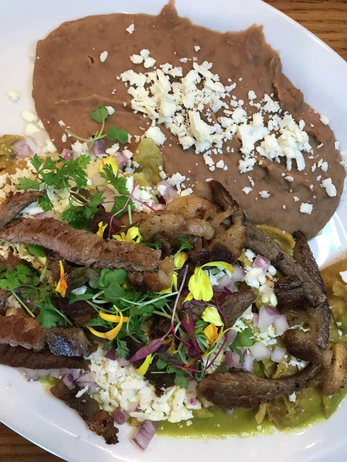 The Chilaquiles Tehuacan at Marla Restaurant is topped with grilled rib-eye.