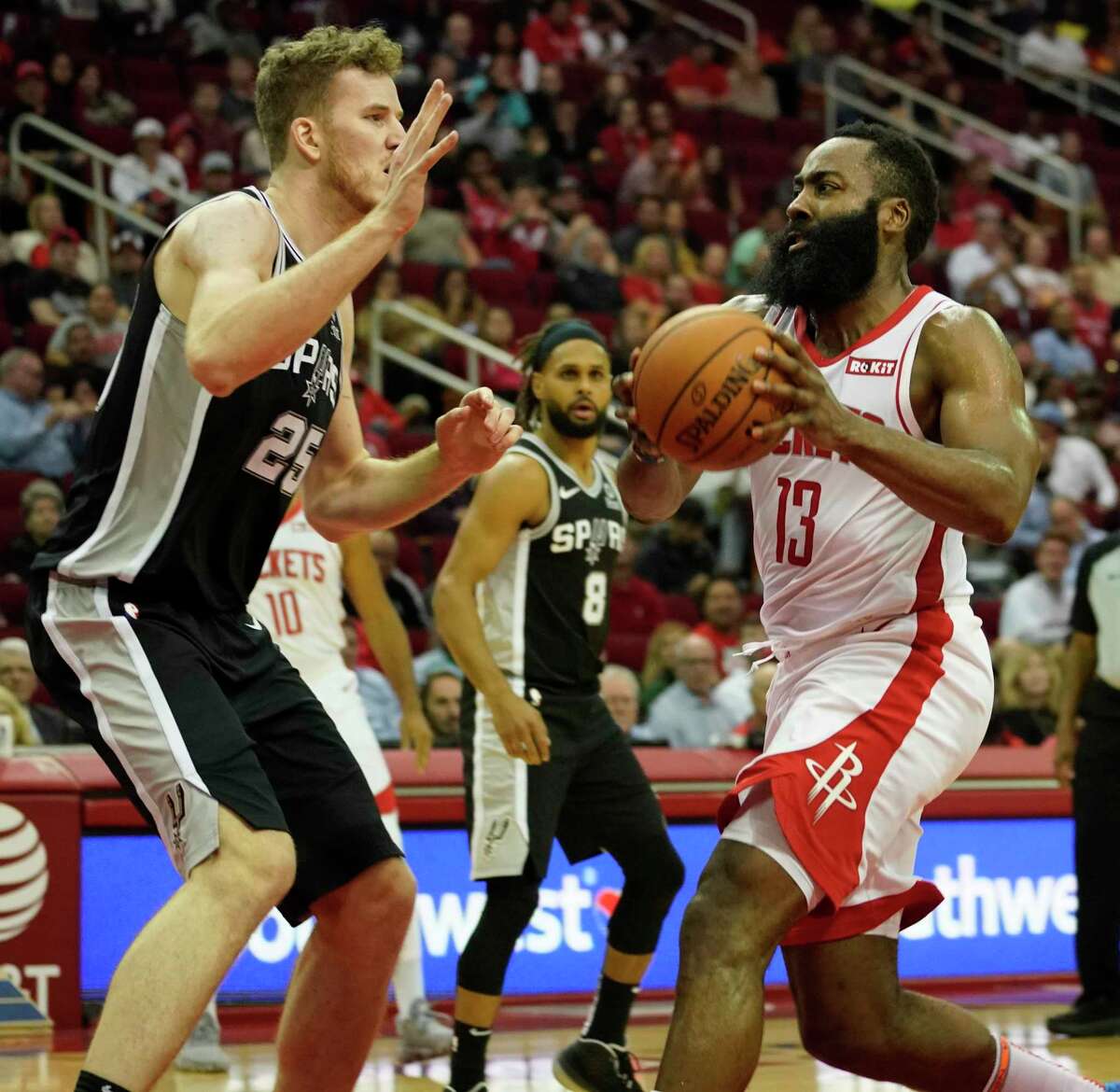 Houston Rockets James Harden moves to the basket past San Antonio Spurs Jakob Poeltl during the second half of NBA game at Toyota Center Wednesday, Oct. 16, 2019, in Houston.