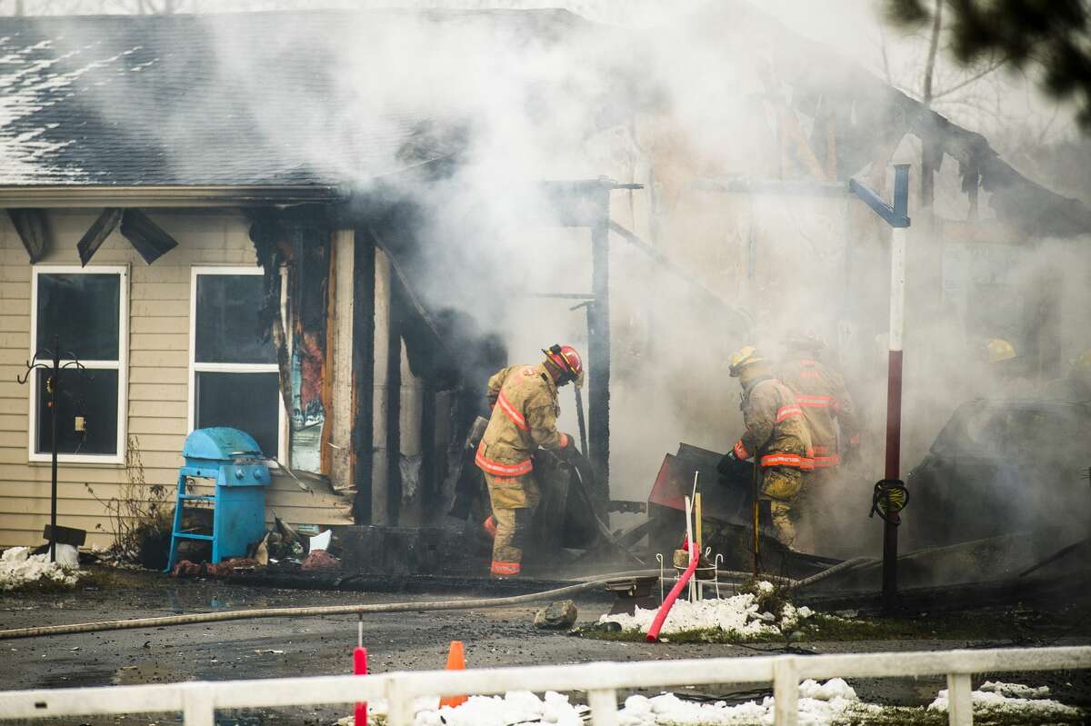 Firefighters from Midland, Homer and Lee Townships work to extinguish a fire at 2231 E. Freeland Road Monday, Dec. 2, 2019 in Ingersoll Township. (Katy Kildee/kkildee@mdn.net)