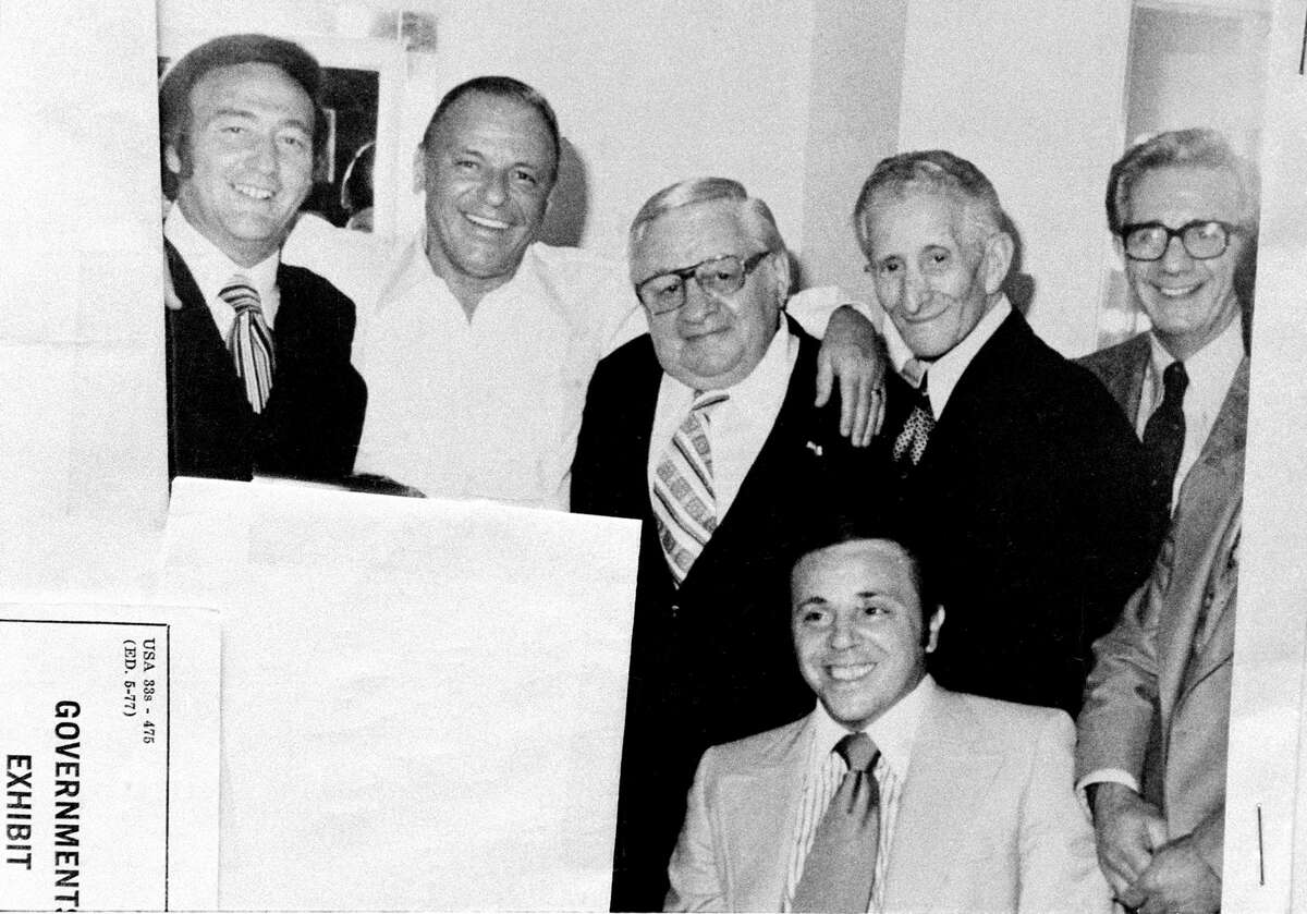 Frank Sinatra poses with friends in his dressing room at Westchester Premier Theater in New York City, Sept. 26, 1976. Shown from left are, Gregory De Palma, Sinatra, Thomas Marson, Carlo Gambino, Jimmy "The Weasel" Fratianno, and in front, Richard "Nerves" Fusco. This photograph was entered as U.S. government exhibit 181 when de Palma and Fusco were on trial charged with fraud in 1978. The U.S. attorney's office blacked out one figure in photo, left. (AP Photo)