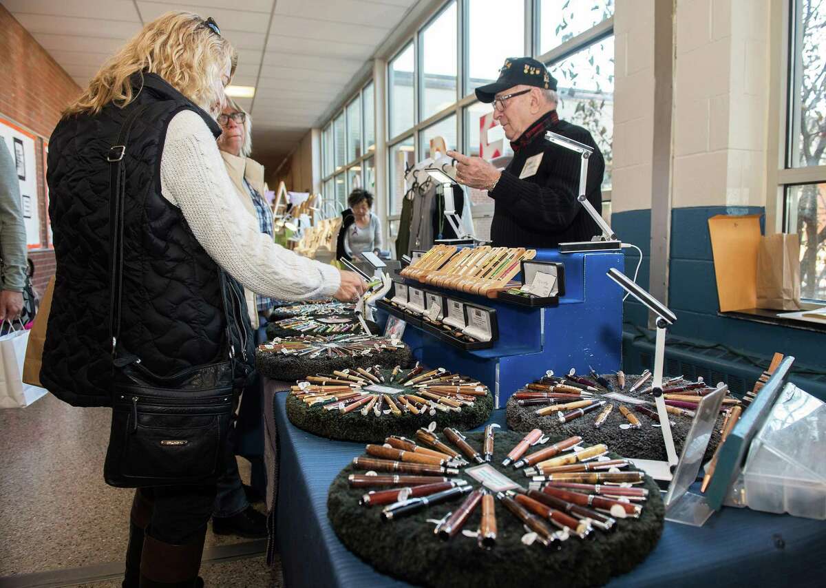 Fair-goers check out pens from As the Wood Turns at The Ridgefield Woman's Club Craft Fair on Saturday 23, November 2019 in Ridgefield, Conn. Fair-goers check out pens from As the Wood Turns at The Ridgefield Woman’s Club Craft Fair on Saturday 23, November 2019 in Ridgefield, Conn.