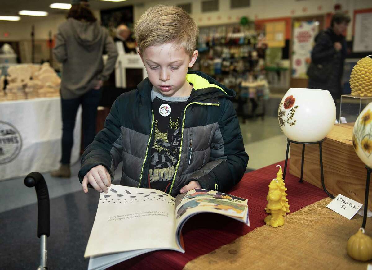 Kastan Extance of Ridgefield reads Reach for the Stars from Ridefield author Kevin Fleming at The Ridgefield Woman's Club Craft Fair on Saturday 23, November 2019 in Ridgefield, Conn. Kastan Extance of Ridgefield reads Reach for the Stars from Ridefield author Kevin Fleming at The Ridgefield Woman’s Club Craft Fair on Saturday 23, November 2019 in Ridgefield, Conn.