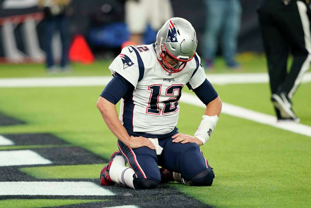 New England Patriots quarterback Tom Brady (12) kneels on the turn after a play during the second half of an NFL football game against the Houston Texans Sunday, Dec. 1, 2019, in Houston. (AP Photo/David J. Phillip)