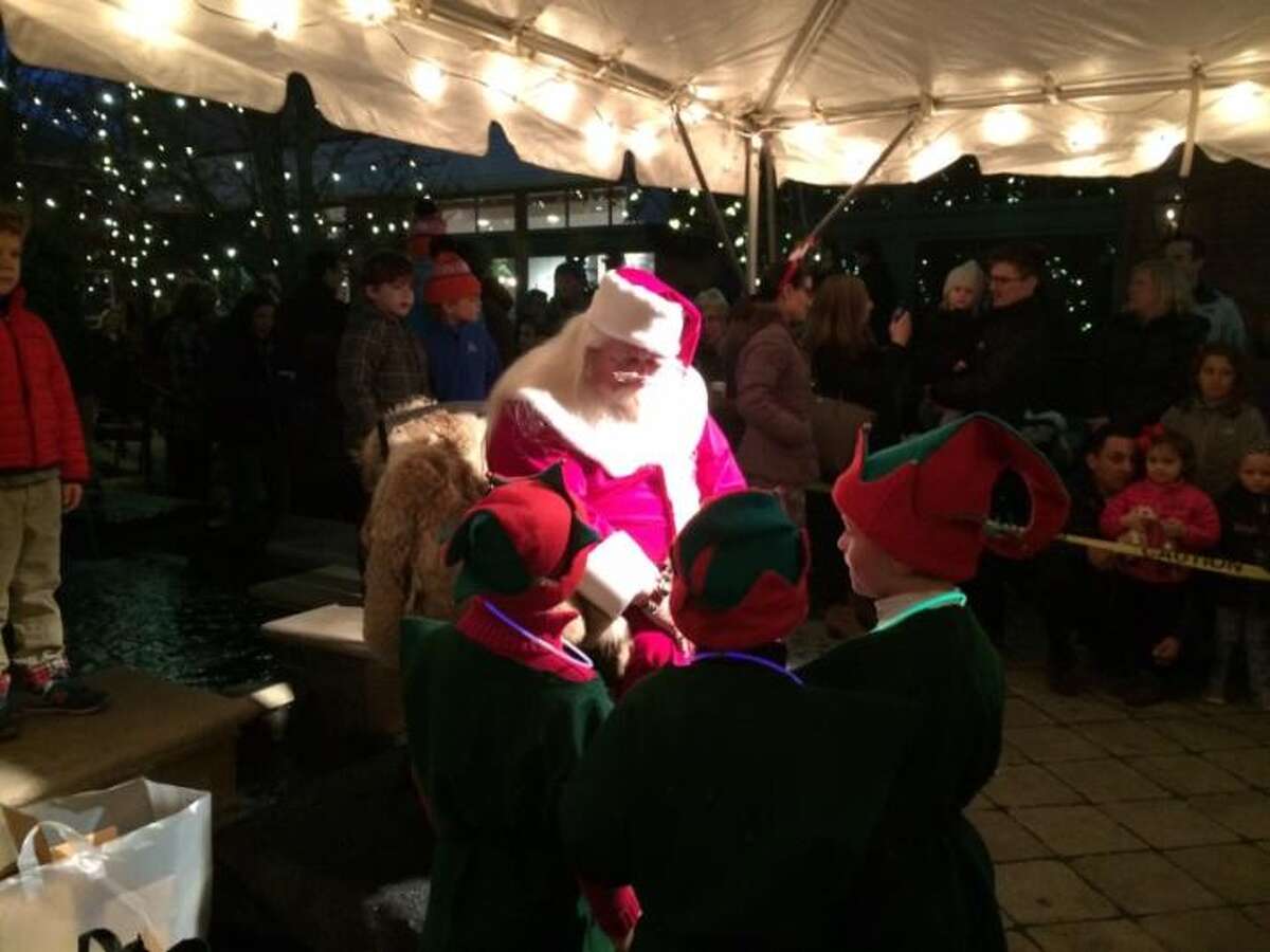 Holiday Magic, along with Santa, seen here giving instructions to elves last year, returns to Grove Street Plaza this Saturday - festivities begin at 4 p.m.