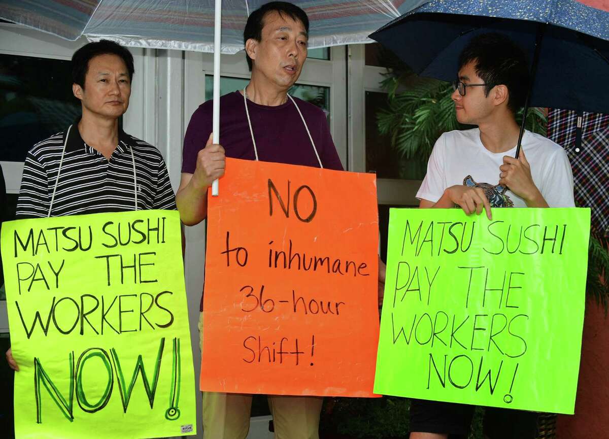 Former Matsu Sushi employees , Jianming Jiang and Liguo Ding and Flushing Workers Center organizer and translator Zishun Ning join State Senator Will Haskell, protestors and labor leaders to protest the firing the two Matsu Sushi staff members during a picket of the restaurant Tuesday, August 13, 2019, in Westport, Conn. The two employees were fired in 2017 after they refused to work three consecutive shifts.