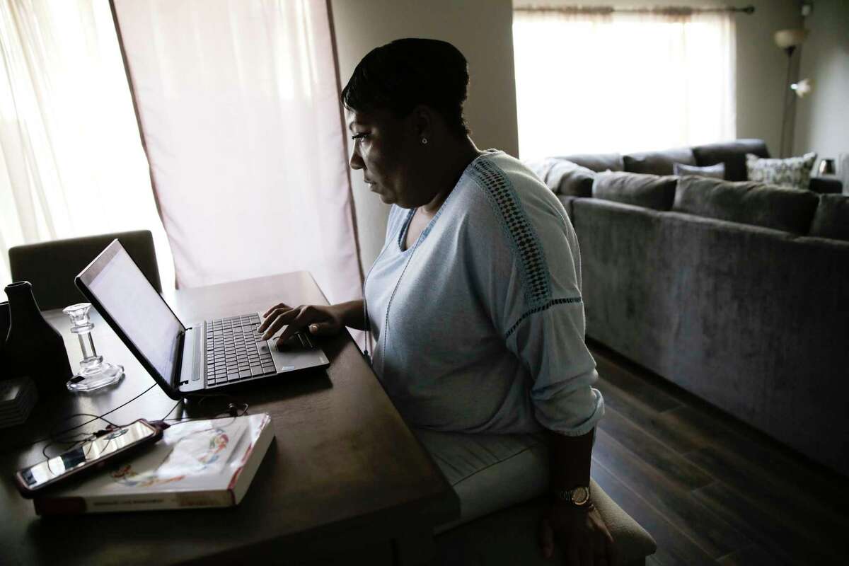 Lovinah Igbani works on her classwork in her Houston home on Sunday, Nov. 24, 2019. Igbani stayed in a shelter after leaving an abusive relationship. Currently, there's a lack of resources and funding causing thousands of victims of domestic violence to be turned away from emergency shelters this year in the Houston region.