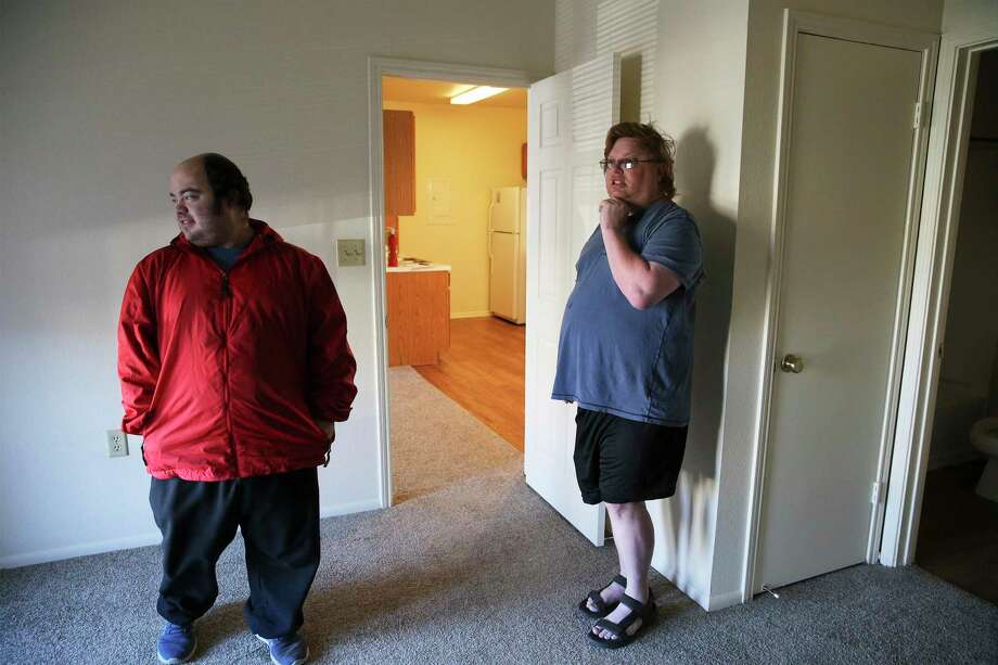 Gary Petersen (right) and his husband, Michael, walk through their new apartment in Boerne, where they eventually moved after they got an eviction notice at their San Antonio rental. The Petersens had paid their rent on time in San Antonio, but were threatened with eviction after filing multiple complaints. Photo: Kin Man Hui / ©2019 San Antonio Express-News