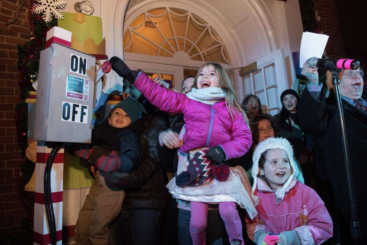 Sophie, 6, of Ridgefield pulls the lever to turn on the holiday lights on Main Street at the the annual Holiday tree-lighting on Friday, Nov. 29, 2019 in Ridgefield Conn. Sophie, 6, of Ridgefield pulls the lever to turn on the holiday lights on Main Street at the the annual Holiday tree-lighting on Friday, Nov. 29, 2019 in Ridgefield Conn.