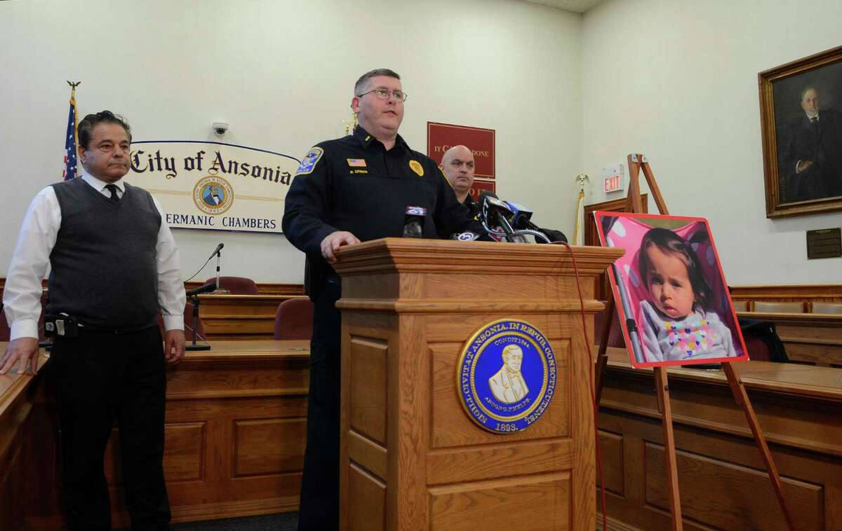 Ansonia Police Lt. Patrick Lynch speaks to the media on a homicide and missing child during a press conference held at Ansonia City Hall in Ansonia, Conn., on Tuesday Dec. 3, 2019. At left is Ansonia Mayor David S. Cassetti and at right is Chief Andrew Cota. One-year-old Vanessa Morales is missing after the body of a woman police believe is the mother was found deceased at a home on Myrtle Avenue.