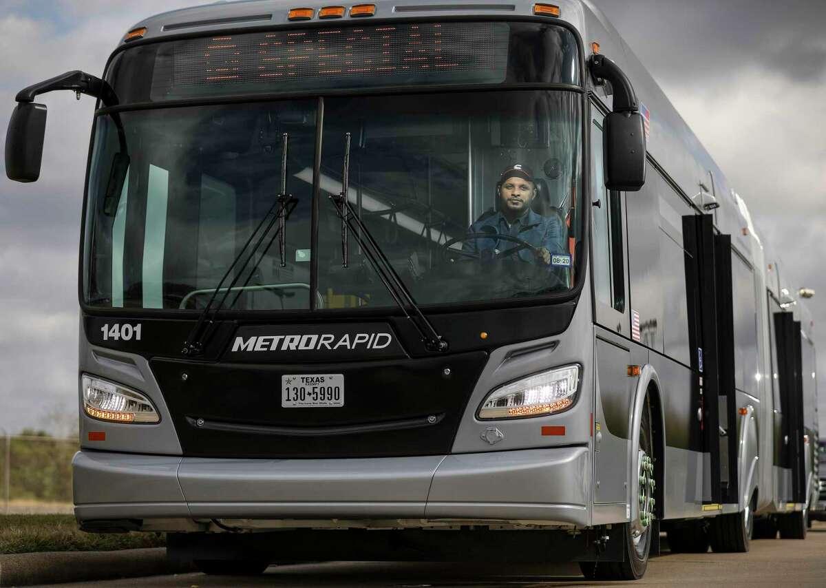 Kevin Abraham, a mechanic with Metropolitan Transit Authority, poses for a photo in one of the new 60-foot buses that will operate the Uptown bus rapid transit line, on Nov. 25, 2019, in Houston. Metro officials plan to begin testing the routes after the holidays, and service is scheduled to begin in March.