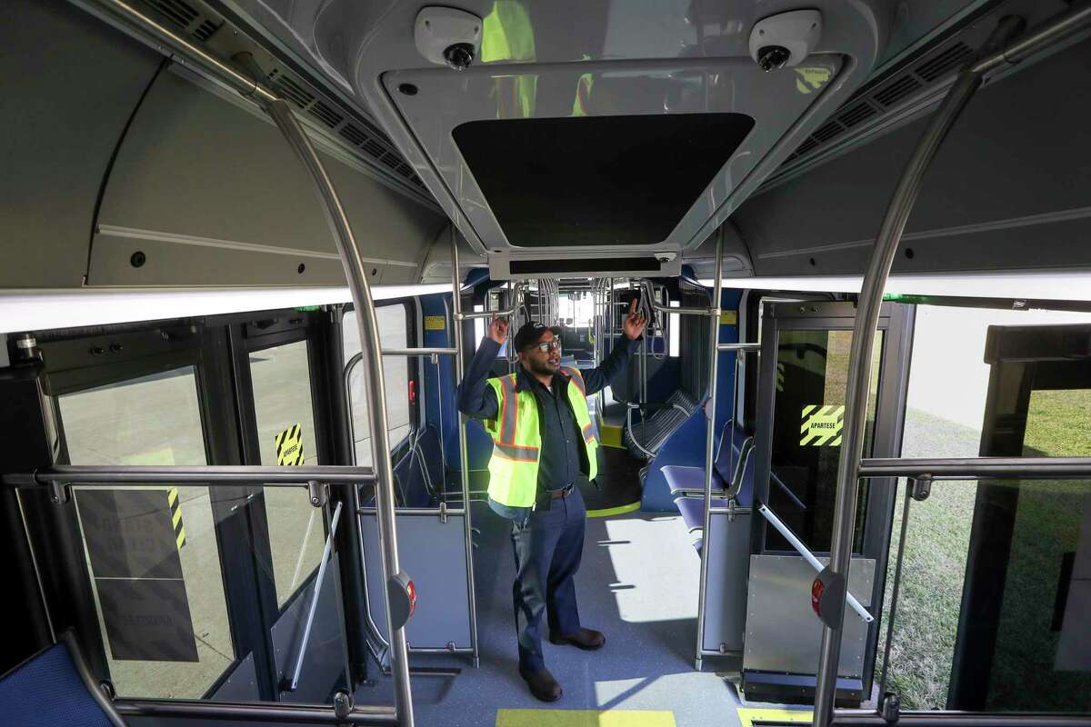 Kevin Abraham, a mechanic with Metropolitan Transit Authority, gives a tour of one of the new 60-foot buses that will operate Uptown bus rapid transit line, on Nov. 25, 2019, in Houston.