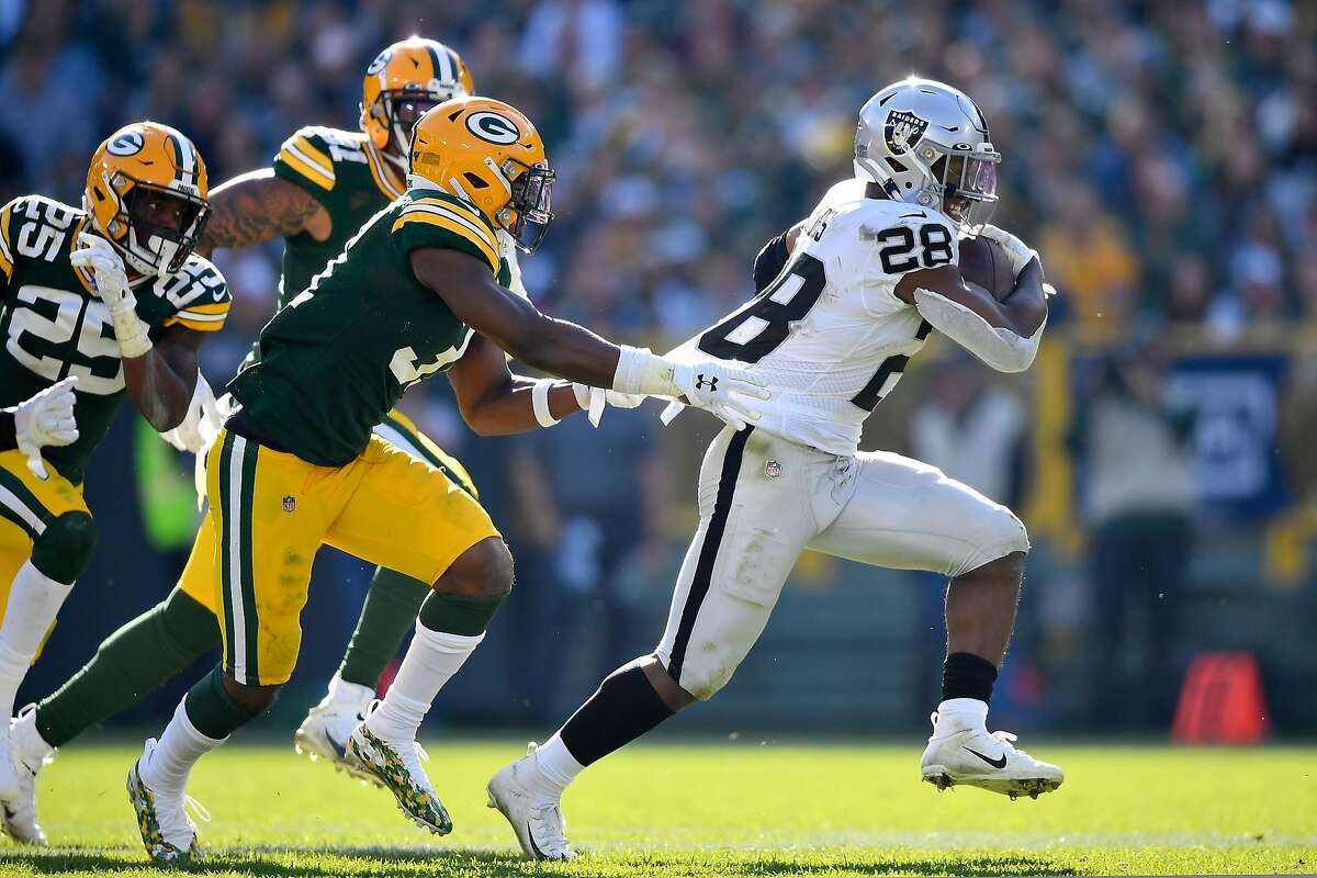GREEN BAY, WISCONSIN - OCTOBER 20: Josh Jacobs #28 of the Oakland Raiders runs with the football in the second half against Adrian Amos #31 of the Green Bay Packers at Lambeau Field on October 20, 2019 in Green Bay, Wisconsin. ~~