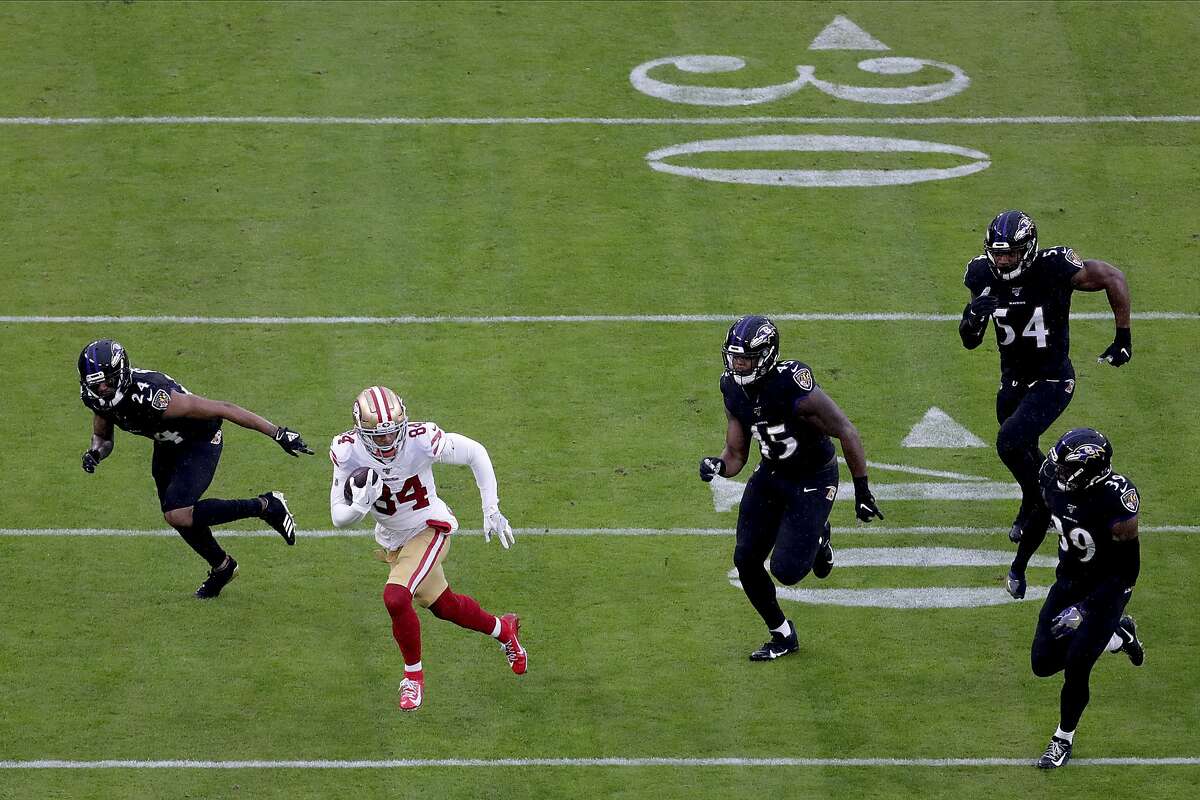 San Francisco 49ers wide receiver Kendrick Bourne (84) runs with the ball as a host of Baltimore Ravens defenders chase him during the first half of NFL football game, Sunday, Dec. 1, 2019, in Baltimore. The Ravens won 20-17. (AP Photo/Julio Cortez)