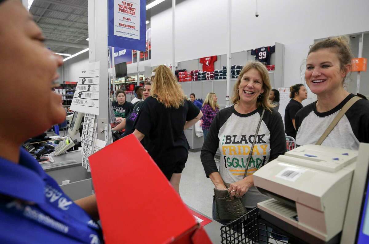 Nancy Conway, 58, and her daughter Amy Clepper, 35, check out after shopping at Academy Sports and Outdoor during Black Friday on Friday, Nov. 29, 2019, in Cypress, Texas.