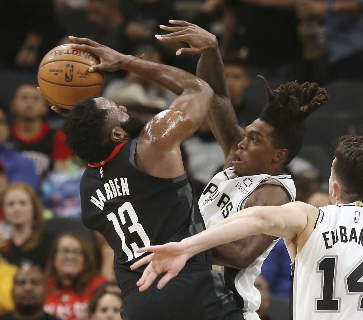 Spurs' Lonnie Walker IV (01) puts pressure on Houston Rockets' James Harden (13) during their game at the AT&T Center on Tuesday, Dec. 3, 2019.