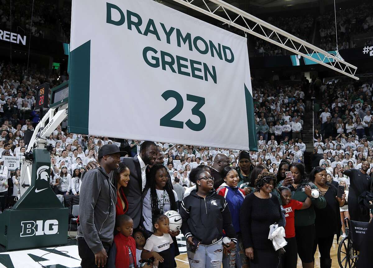 Former Michigan State and current Golden State Warriors player Draymond Green stands with family members during a ceremony in which his jersey number was retired, at halftime of an NCAA college basketball game between Michigan State and Duke, Tuesday, Dec. 3, 2019, in East Lansing, Mich. (AP Photo/Al Goldis)