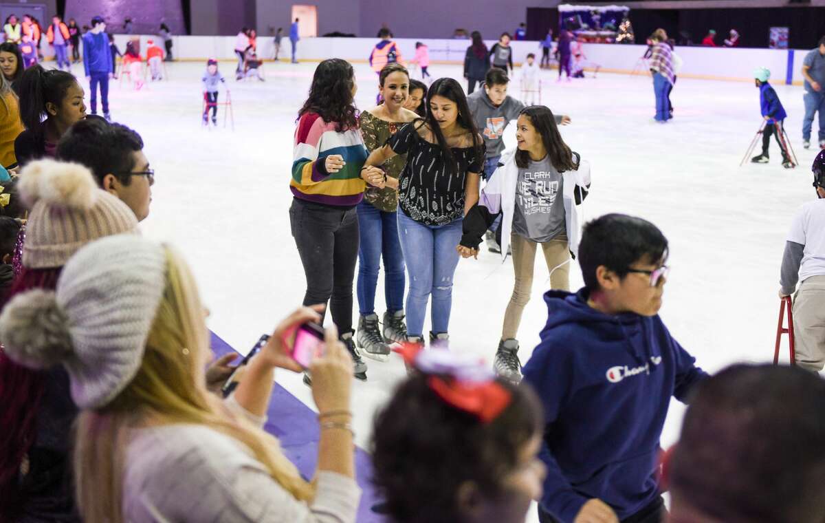 Families show up to see the lighting of the Christmas tree, ice skating and photos with Santa at the Sames Auto Arena during the 7th Annual Navidadfest.