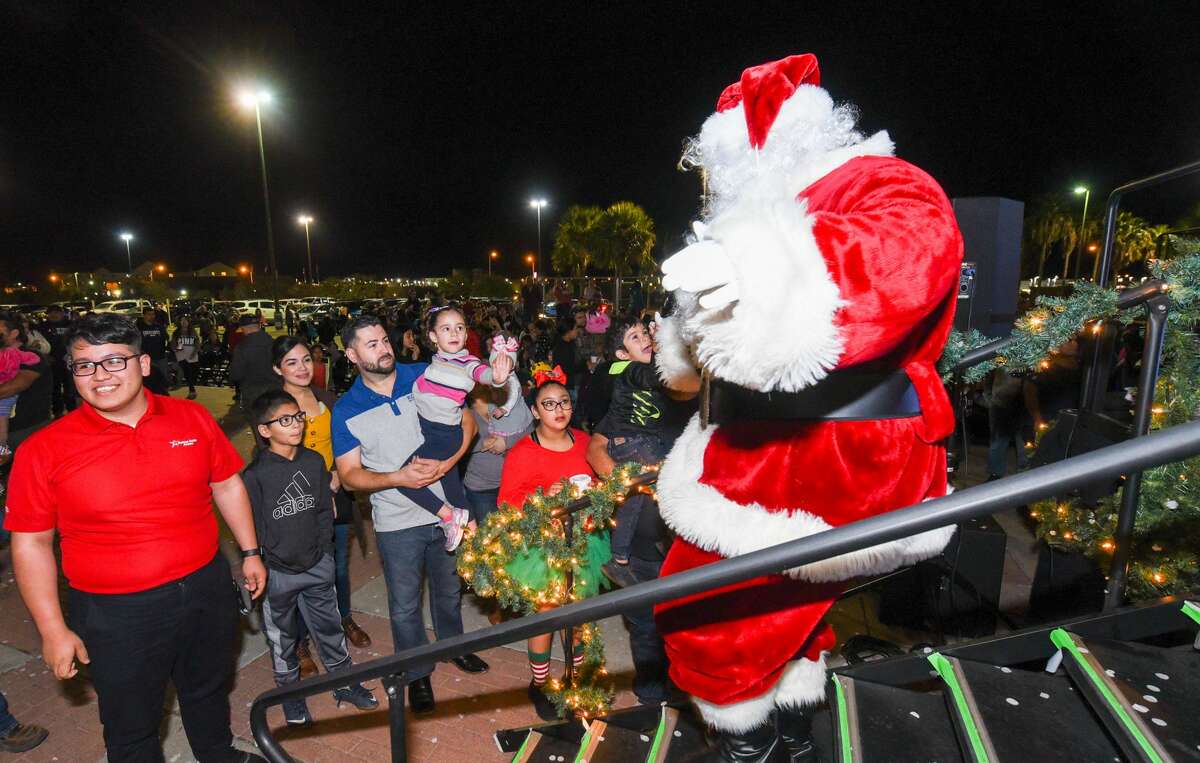 Families turn out to see the Christmas tree lighting, ice skating and photos with Santa at the Sames Auto Arena during the 7th annual Navidadfest.
