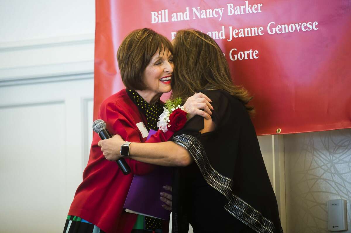 Nancy Barker, left, hugs Julie Nunn, executive director for Cancer Services of Midland, right, during the organization's 28th Annual Holiday Luncheon & Style Show Wednesday, Dec. 4, 2019 at Midland Country Club. (Katy Kildee/kkildee@mdn.net)
