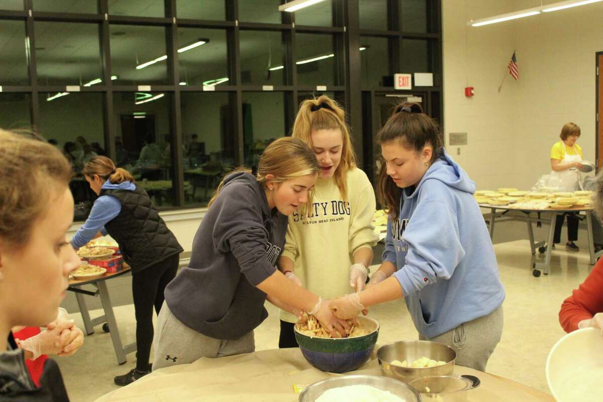 Mercy High School students mix ingredients for their pies.