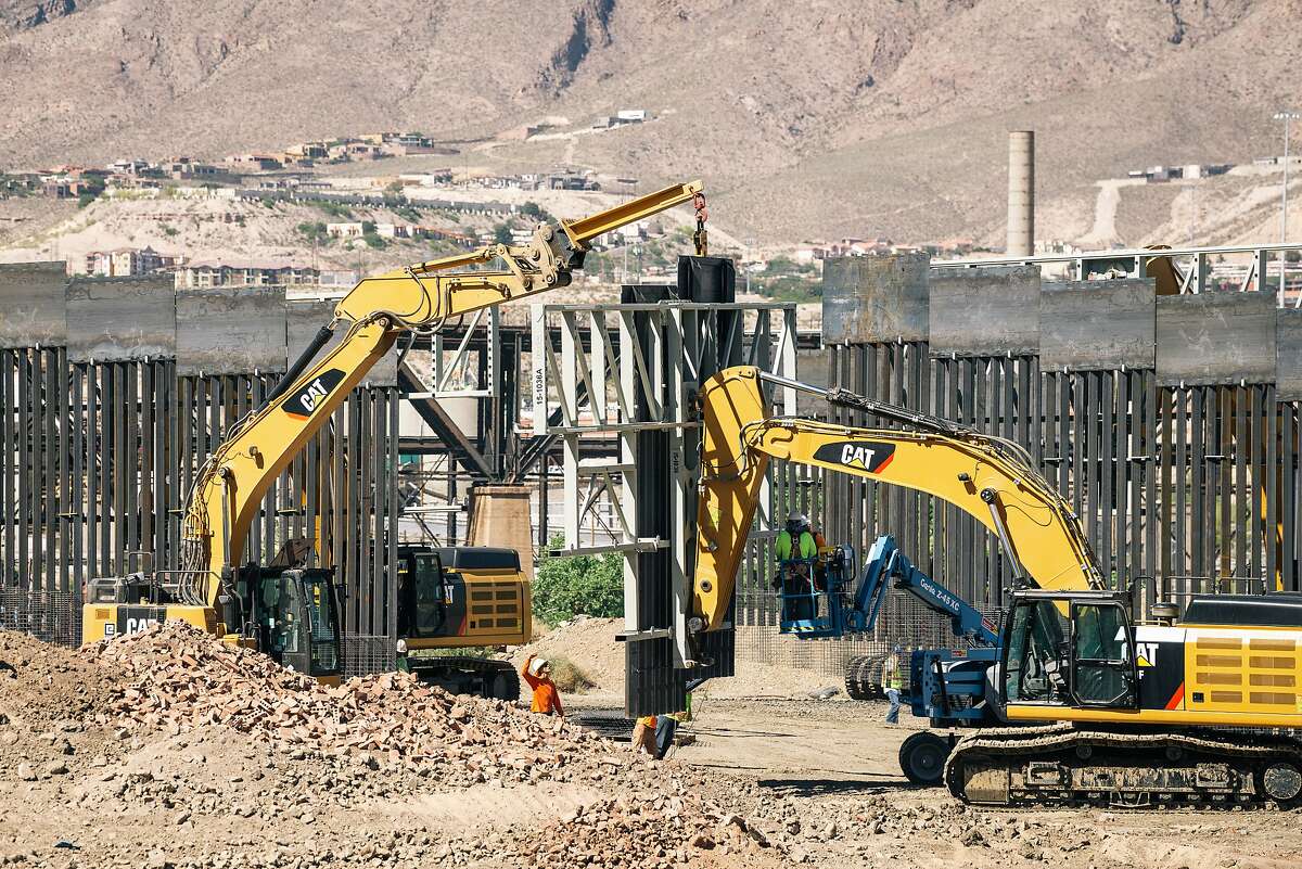 Fisher Industries workers drop pieces of wall into place on May 24, 2019, on land owned by American Eagle Brick Co. in Sunland Park, N.M., near the U.S.-Mexico border. The project was pursued by a right-wing group, We Build the Wall, which is also trying to erect steel fencing along the banks of the Rio Grande in Texas. MUST CREDIT: Photo for The Washington Post by Jordyn Rozensky and Justin Hamel