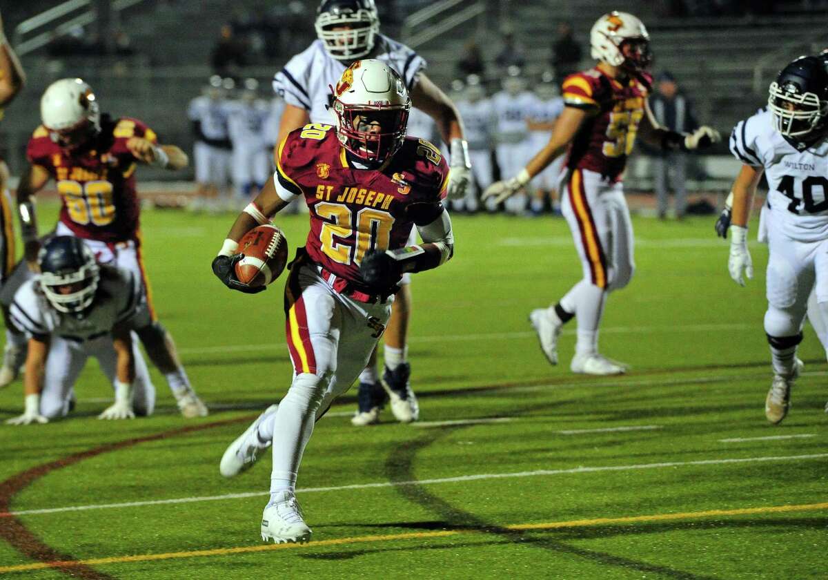 St. Joseph’s Jaden Shirden (20) runs to the end zone to score a touchdown against Wilton in the CIAC Class L quarterfinals on Wednesday in Trumbull.