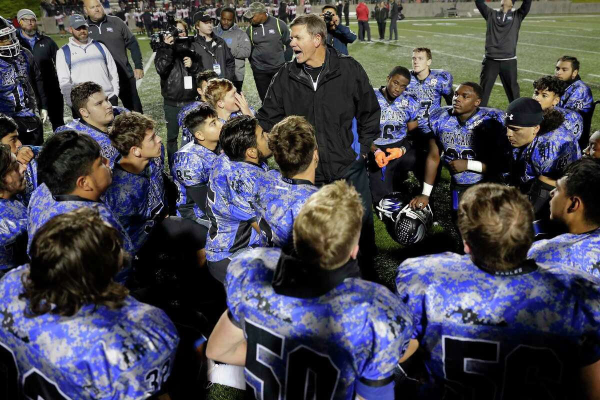 New Caney head coach Brady Pennington, center, talks with his players after defeating Porter in their District 9-5A high school football game late last season.