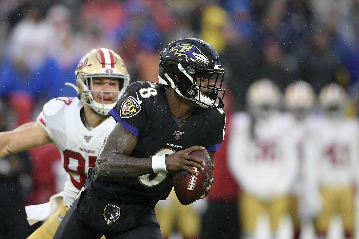 Baltimore Ravens quarterback Lamar Jackson (8) runs with the ball in the first half of an NFL football game against the San Francisco 49ers, Sunday, Dec. 1, 2019, in Baltimore, Md. (AP Photo/Nick Wass)