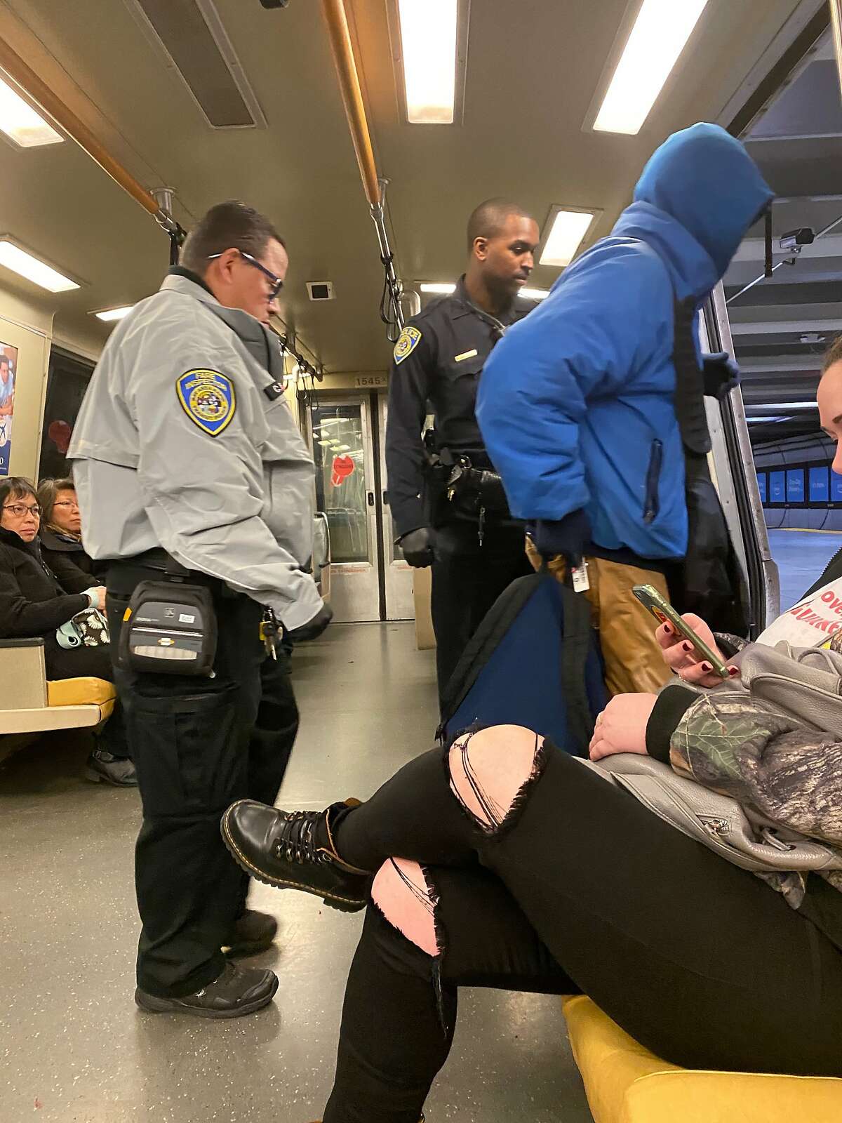 Police and BART fare control officer conduct sweep of Berkeley- bound train at the Embarcadero Station on Monday, Dec., 2, 2019, and escort fare evader off of the train.