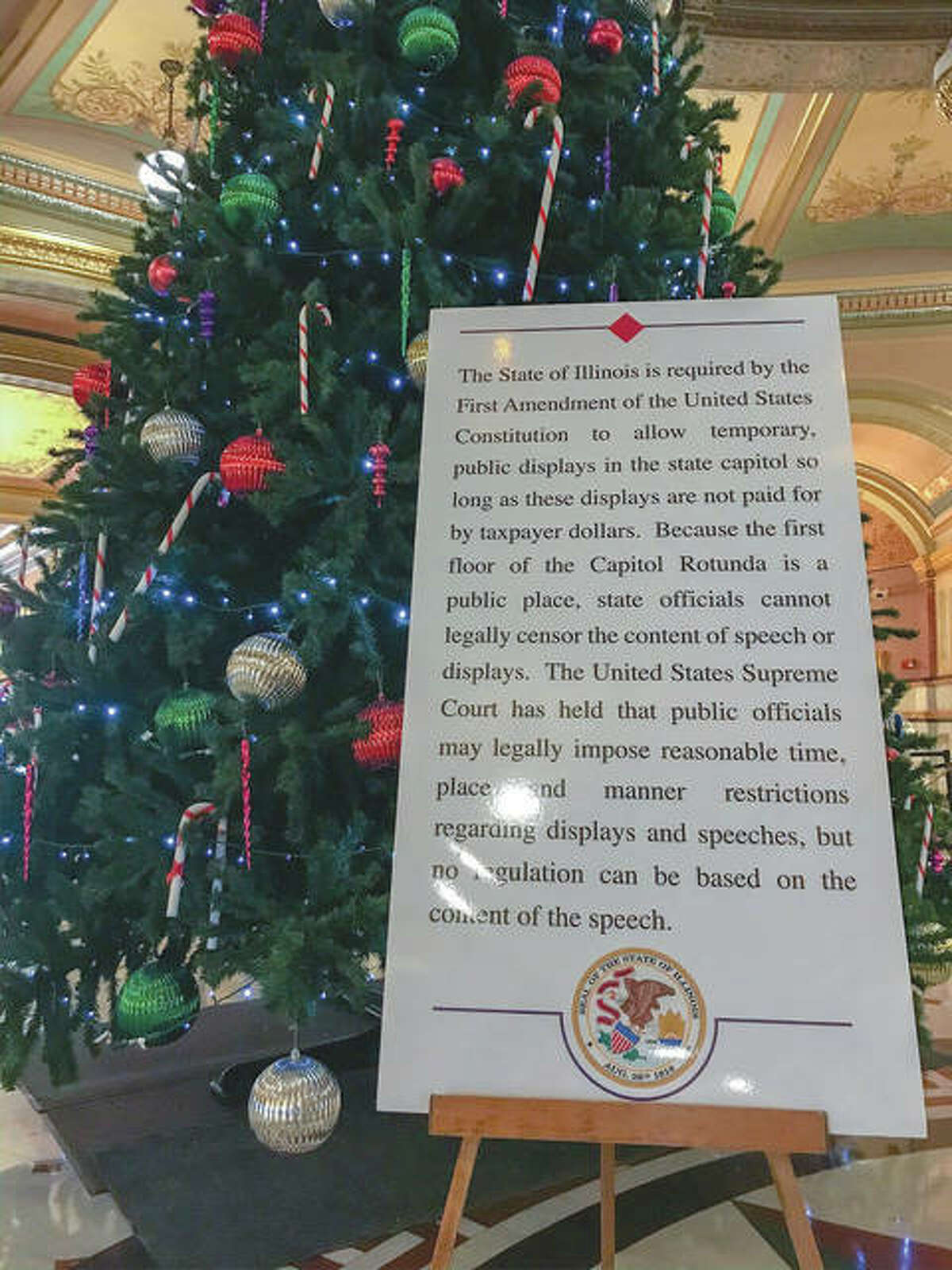 A sign on the Illinois State Capitol Rotunda clarifies the state’s policy on holiday displays.