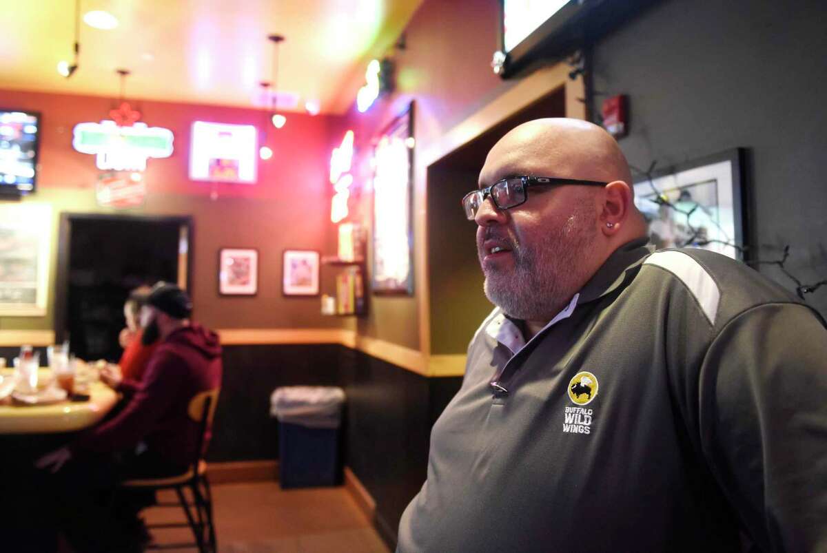 Buffalo Wilds Wings Bar Manager Tony López, a lifelong Mets fan, chats about the new ownership of the New York Mets during his shift at Buffalo Wild Wings in Stamford, Conn. Thursday, Dec. 5, 2019. The Mets are in negotiation to sell the team to Steve Cohen, the President and CEO of Stamford hedge fund Point72, in a deal that will take five years to complete.
