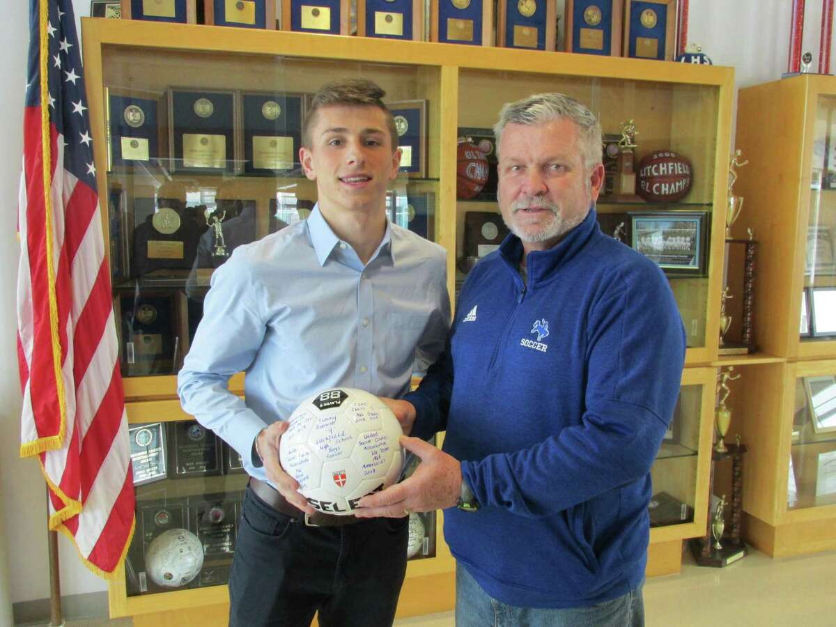 Litchfield soccer coach Rob Andrulis presented Timmy Donovan with a soccer ball commemorating Donovan’s selection as a first-team U.S. Soccer Coaches Association All-American Wednesday afternoon at Litchfield High School.