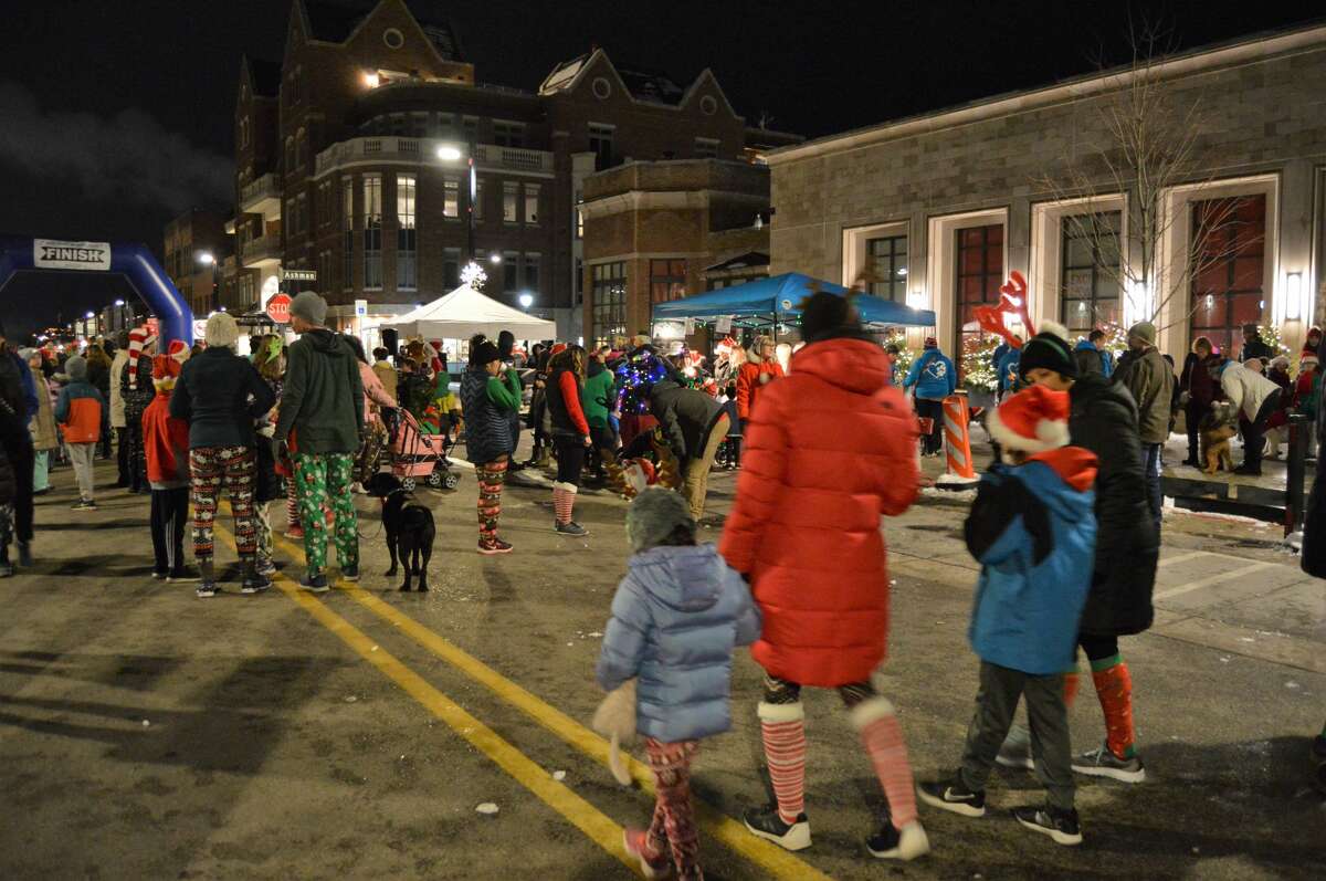 Members of the community, many of which were dressed in holiday-themed gear, gathered in downtown Midland for the Jingle Bell Fun Run/Walk on Thursday, Dec. 5, 2019. (Ashley Schafer/Ashley.Schafer@hearstnp.com)