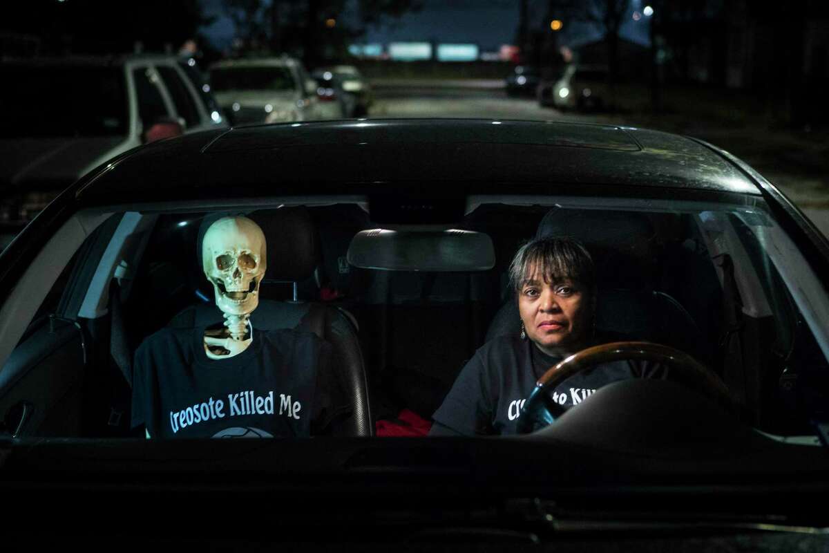 Leisa Glenn sits in her car with a skeleton her group has dubbed "Creosote Man" in their Fifth Ward neighborhood on Thursday, Dec. 5, 2019, in Houston. A cancer cluster was identified in the the historically black north Houston neighborhoods of the Fifth Ward and Kashmere Gardens, near a site of legacy contamination from rail yard operations. Creosote was used for decades to treat wooden railroad ties in the yard. Though wood treatment has ceased for many years, the creosote sunk deep into the ground, creating a plume that has moved beneath an estimated 110 homes. The cancers identified in the cluster are associated with the contaminants found in creosote.