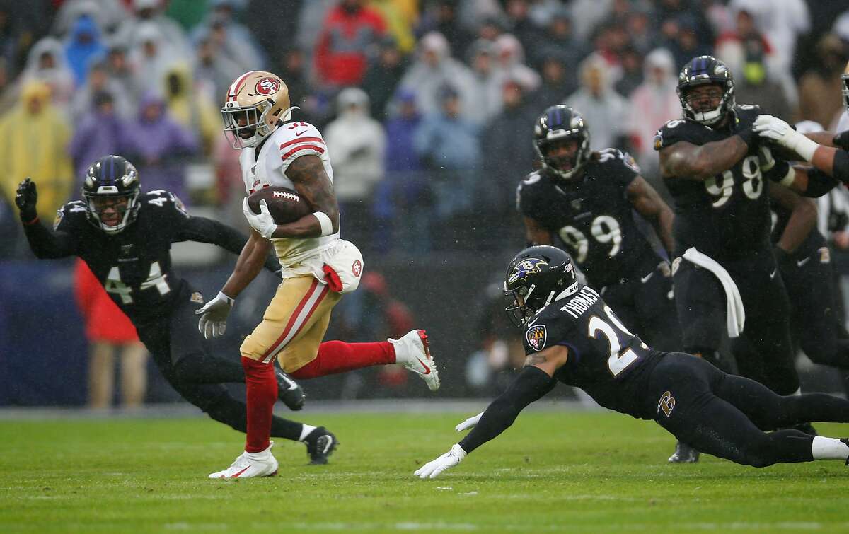 San Francisco 49ers running back O.J. Simpson looks over his