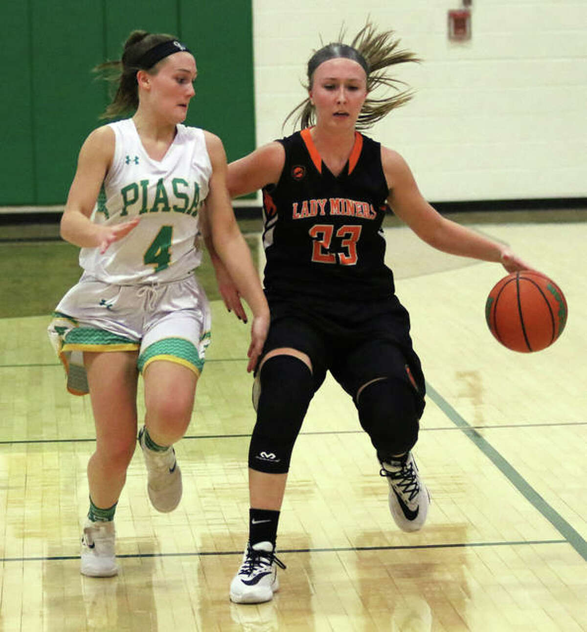 Gillespie’s Emily Schmidt (right) brings the ball upcourt against pressure from Southwestern’s Josie Bouillon during a SCC girls basketball game Thursday night in Piasa.