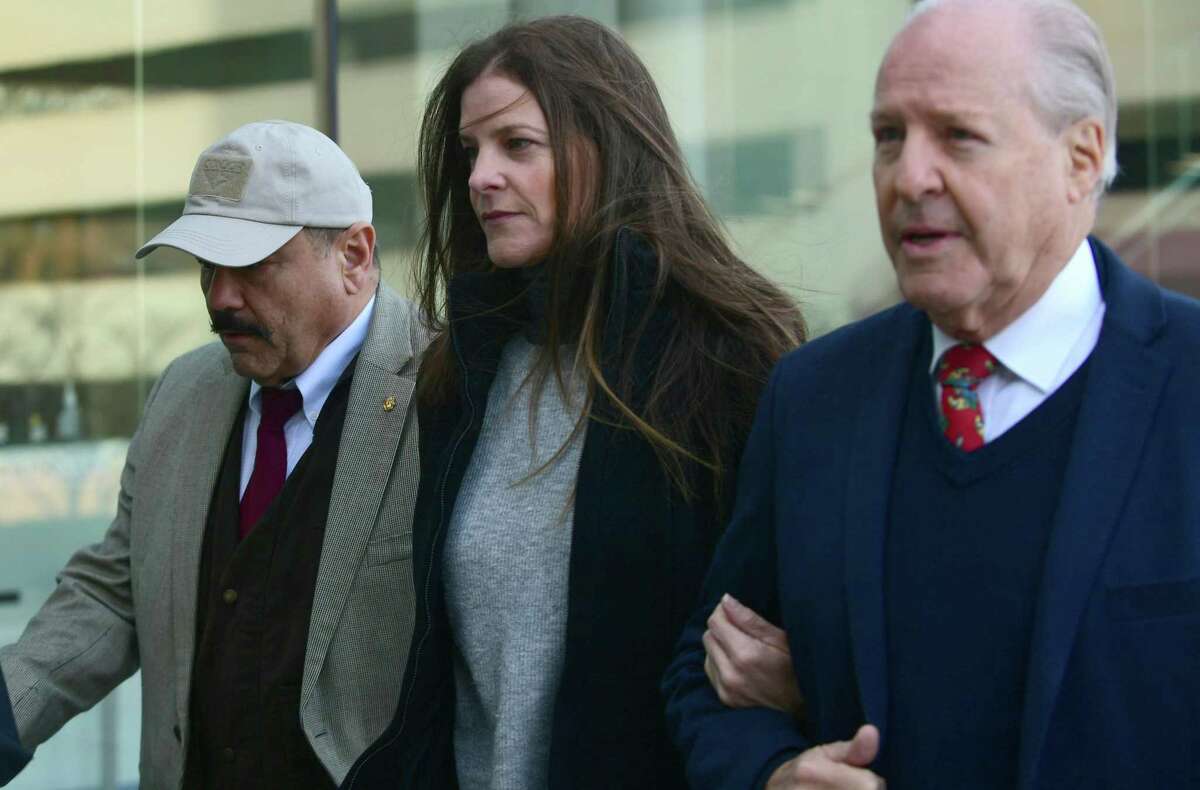Michelle Troconis arrives with her father, Dr. Carlos Troconis, right, at state Superior Court in Stamford on Friday.